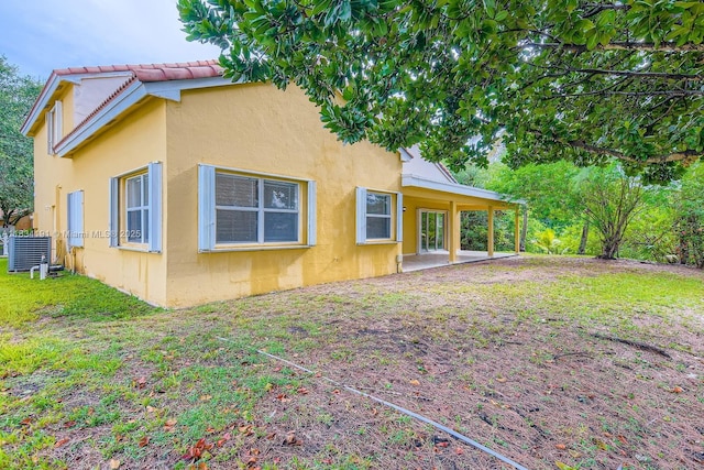 12700 SW 18th St, Miramar, FL 33027 - back of house with stucco siding, a patio, and a yard