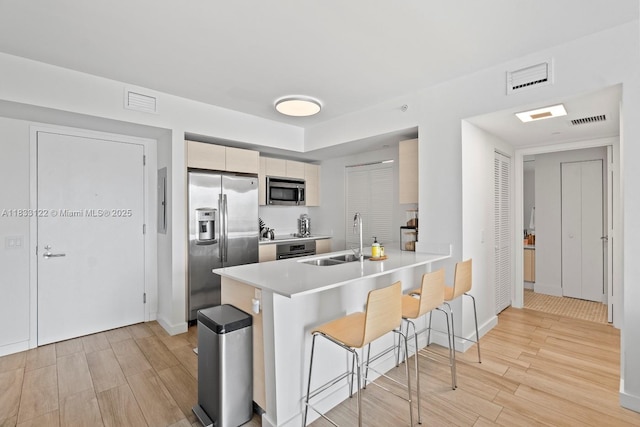4250 Biscayne Blvd Unit 1218, Miami, FL 33137 - kitchen featuring stainless steel appliances, light wood-type flooring, a kitchen breakfast bar, a peninsula, and light countertops