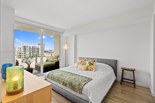 4250 Biscayne Blvd Unit 1218, Miami, FL 33137 - bedroom featuring access to outside, a city view, wood finished floors, and expansive windows