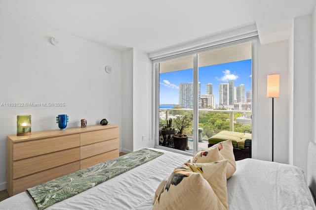 4250 Biscayne Blvd Unit 1218, Miami, FL 33137 - bedroom featuring a wall of windows, a skyline view, access to outside, and wood finished floors