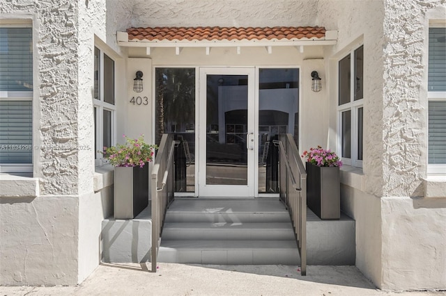 403 SW 12th Ave, Miami, FL 33130 - view of exterior entry featuring stucco siding and a tile roof