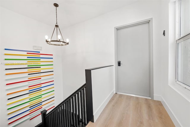 403 SW 12th Ave, Miami, FL 33130 - hallway featuring an upstairs landing, a chandelier, and light wood-style flooring
