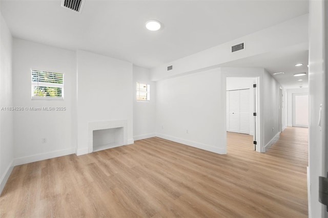 403 SW 12th Ave, Miami, FL 33130 - unfurnished living room with light wood-style flooring and baseboards