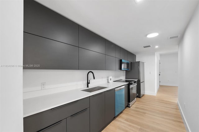 403 SW 12th Ave, Miami, FL 33130 - kitchen featuring stainless steel appliances, light wood-type flooring, light countertops, and modern cabinets