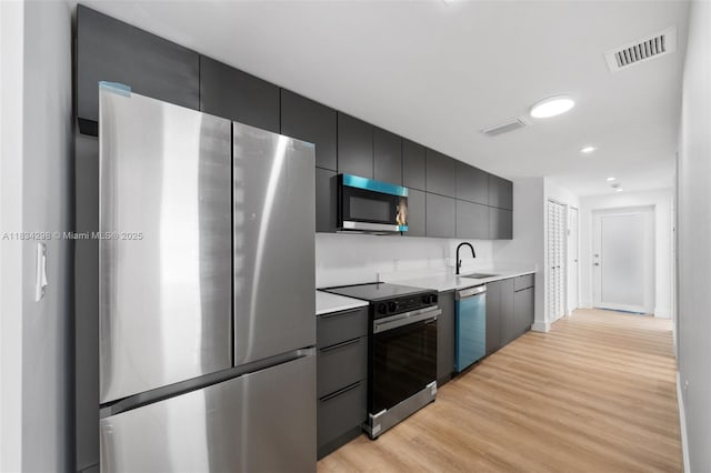 403 SW 12th Ave, Miami, FL 33130 - kitchen with appliances with stainless steel finishes, light wood-style flooring, light countertops, modern cabinets, and recessed lighting