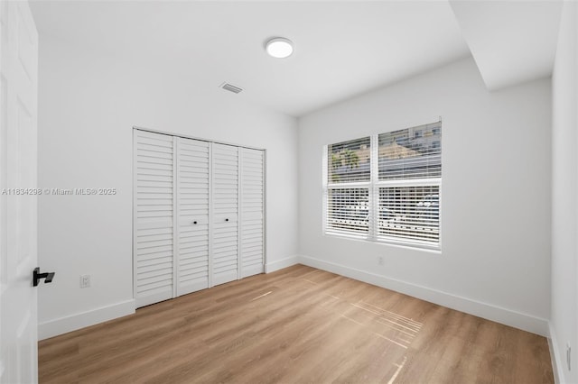 403 SW 12th Ave, Miami, FL 33130 - unfurnished bedroom with light wood-style floors and a closet
