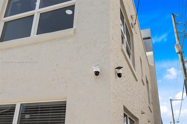 403 SW 12th Ave, Miami, FL 33130 - exterior view of stucco siding and a security system