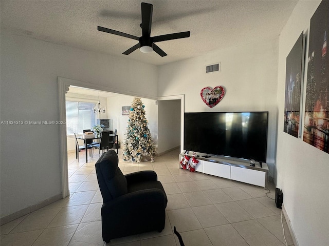 5344 Bosque Ln Unit 104, West Palm Beach, FL 33415 - tiled living area featuring a ceiling fan, a textured ceiling, and a chandelier