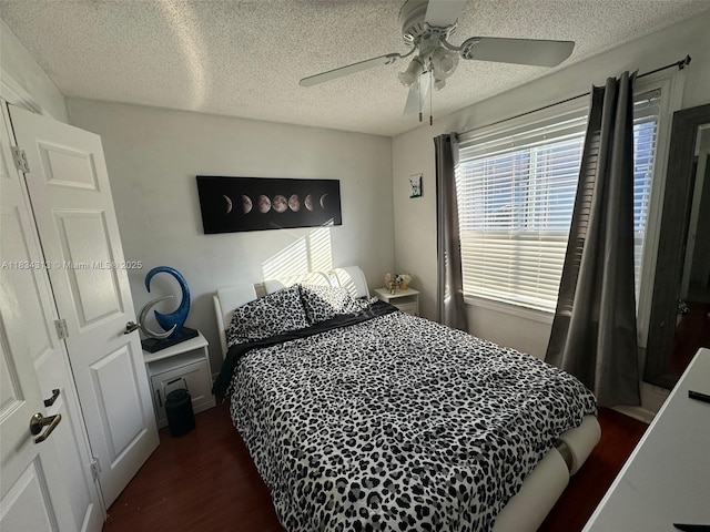 5344 Bosque Ln Unit 104, West Palm Beach, FL 33415 - bedroom with dark wood finished floors, a ceiling fan, and a textured ceiling