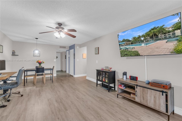 6193 Rock Island Rd Unit 216, Tamarac, FL 33319 - home office with light wood-style floors, ceiling fan, and a textured ceiling