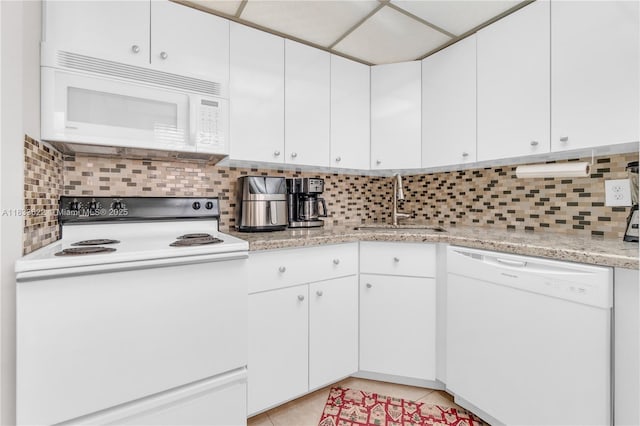 6193 Rock Island Rd Unit 216, Tamarac, FL 33319 - kitchen with white appliances, tasteful backsplash, and white cabinets