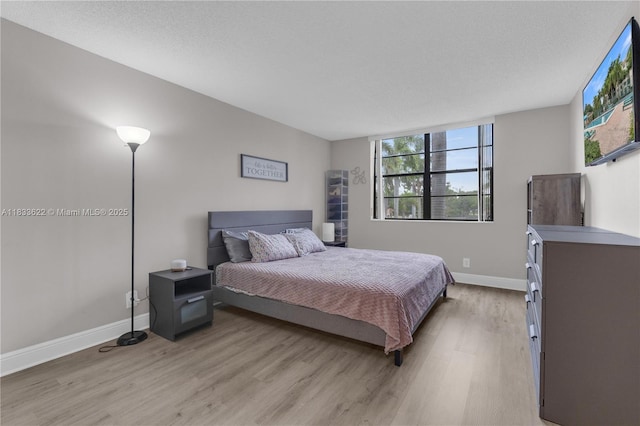 6193 Rock Island Rd Unit 216, Tamarac, FL 33319 - bedroom with light wood-type flooring and multiple windows