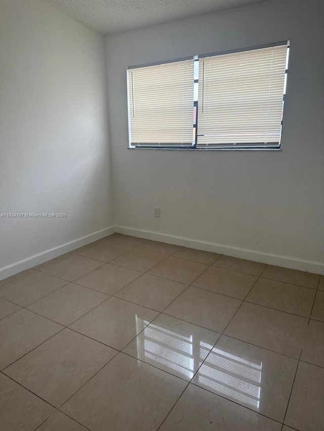 2225 W 53rd Pl Unit 2225, Hialeah, FL 33016 - unfurnished room featuring light tile patterned floors and baseboards