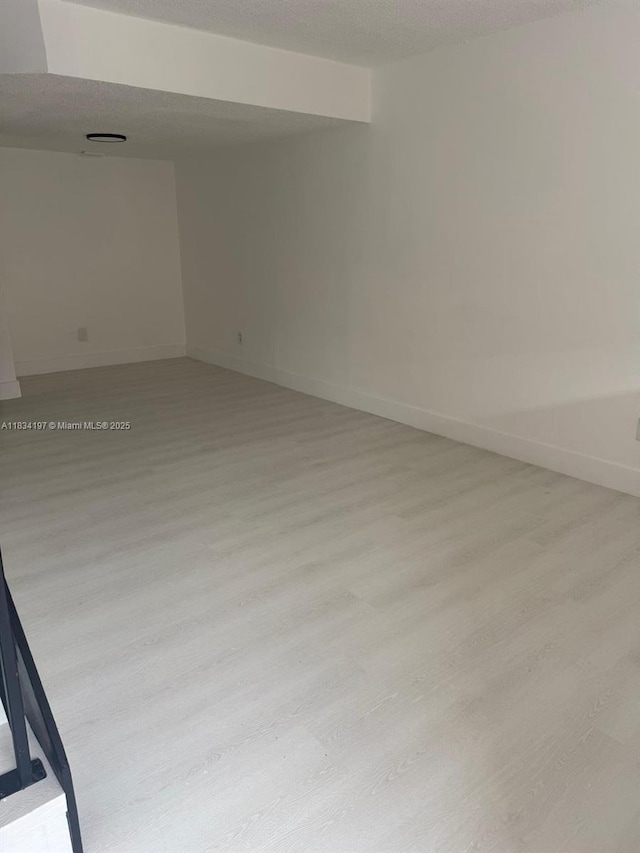 2225 W 53rd Pl Unit 2225, Hialeah, FL 33016 - empty room with light wood finished floors and a textured ceiling