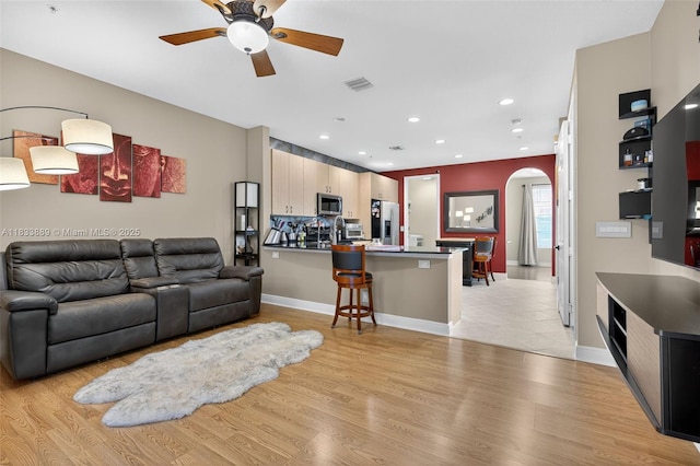 153 Apalachee Ln, Jupiter, FL 33458 - living area featuring arched walkways, ceiling fan, light wood-style flooring, and recessed lighting
