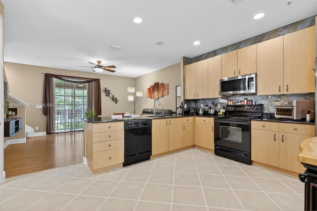 153 Apalachee Ln, Jupiter, FL 33458 - kitchen featuring black appliances, light brown cabinetry, a peninsula, dark countertops, and recessed lighting