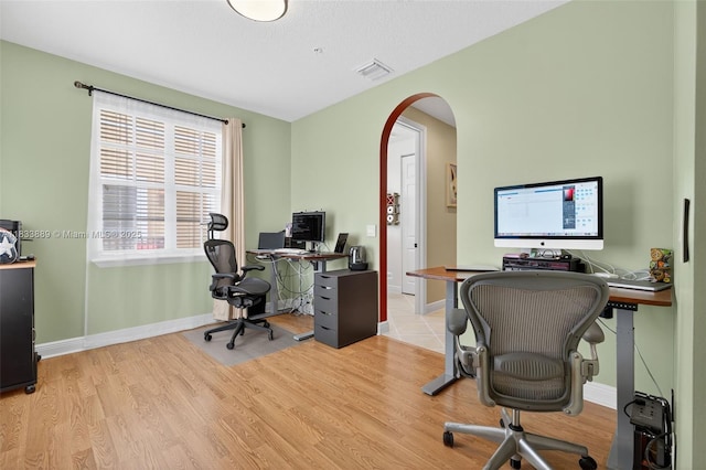 153 Apalachee Ln, Jupiter, FL 33458 - office area featuring arched walkways and light wood-style floors
