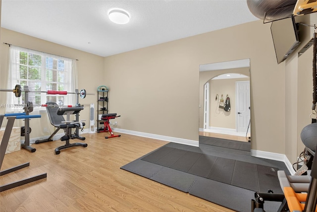 153 Apalachee Ln, Jupiter, FL 33458 - workout room with wood finished floors and arched walkways