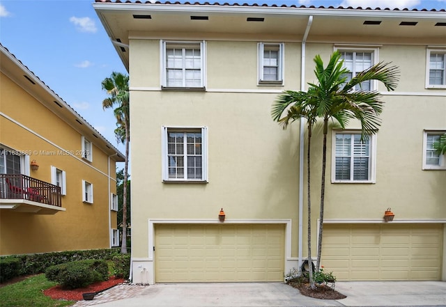 153 Apalachee Ln, Jupiter, FL 33458 - multi unit property featuring an attached garage, stucco siding, and concrete driveway