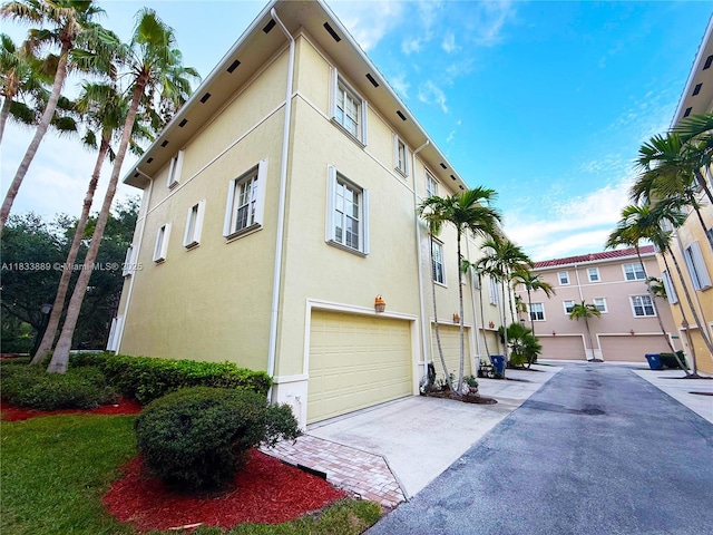 153 Apalachee Ln, Jupiter, FL 33458 - view of property with concrete driveway and a garage