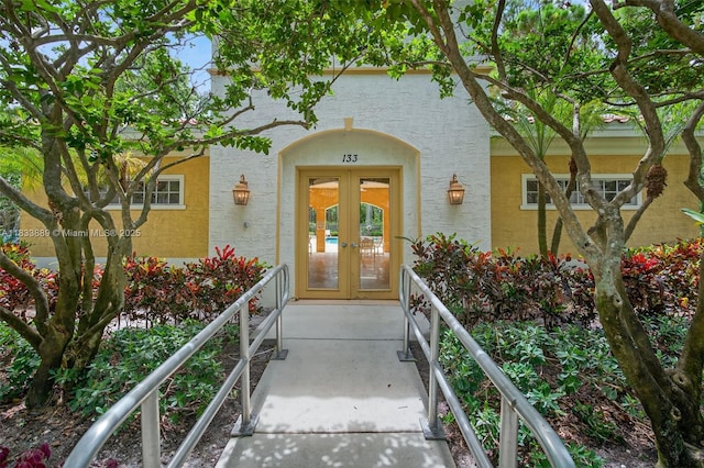 153 Apalachee Ln, Jupiter, FL 33458 - entrance to property featuring french doors and stucco siding