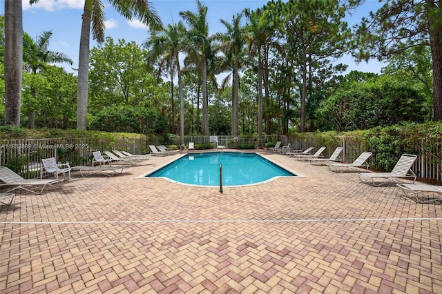 153 Apalachee Ln, Jupiter, FL 33458 - community pool with a patio and view of scattered trees