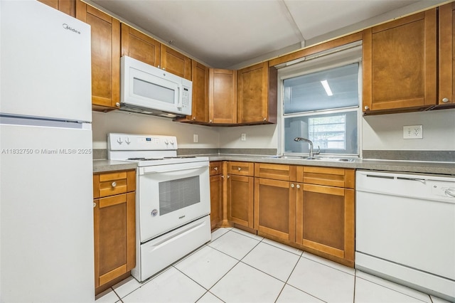 4931 NW 13th St, Lauderhill, FL 33313 - kitchen featuring white appliances, brown cabinets, and light tile patterned flooring