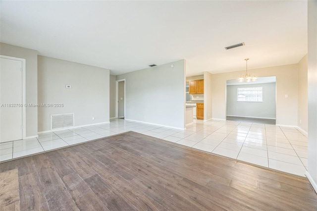 4931 NW 13th St, Lauderhill, FL 33313 - unfurnished living room with a chandelier and light tile patterned floors
