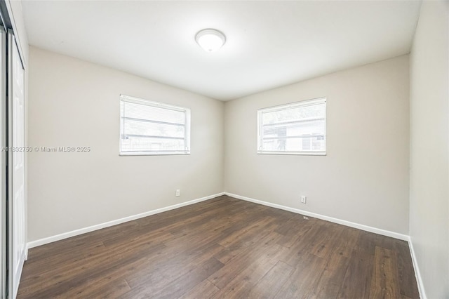 4931 NW 13th St, Lauderhill, FL 33313 - empty room featuring dark wood-style floors and baseboards