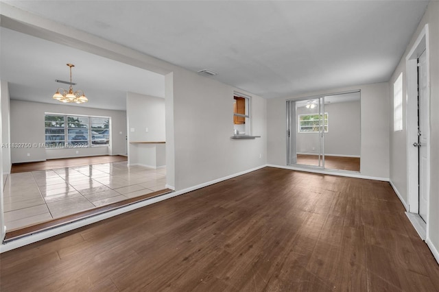 4931 NW 13th St, Lauderhill, FL 33313 - empty room with a chandelier, wood finished floors, and healthy amount of natural light
