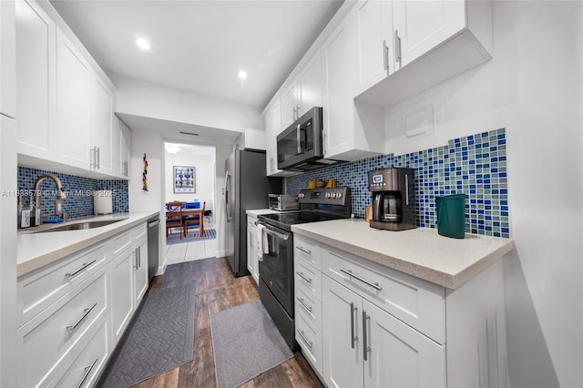 4330 Hillcrest Dr Unit 104, Hollywood, FL 33021 - kitchen with stainless steel appliances, dark wood-style floors, tasteful backsplash, white cabinets, and recessed lighting