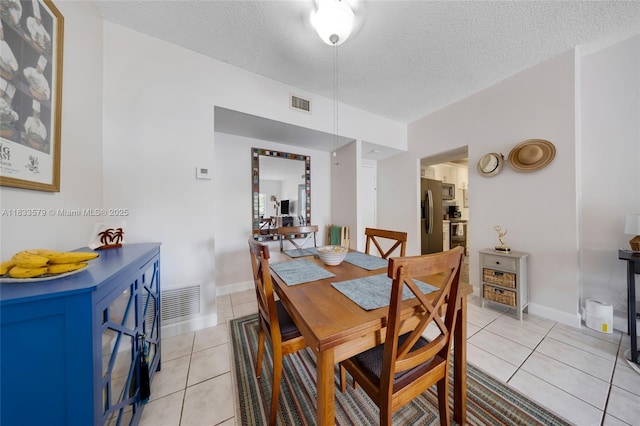 4330 Hillcrest Dr Unit 104, Hollywood, FL 33021 - dining area with light tile patterned flooring and a textured ceiling