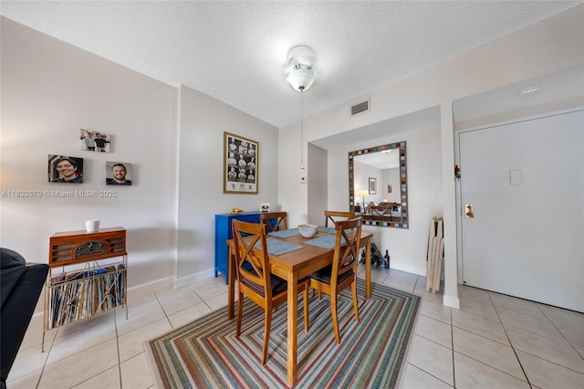 4330 Hillcrest Dr Unit 104, Hollywood, FL 33021 - dining space featuring light tile patterned flooring and a textured ceiling