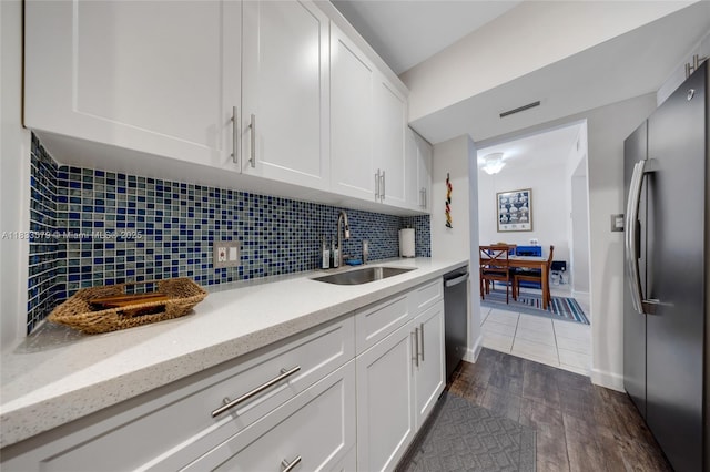 4330 Hillcrest Dr Unit 104, Hollywood, FL 33021 - kitchen featuring stainless steel appliances, white cabinets, dark wood-style flooring, and decorative backsplash