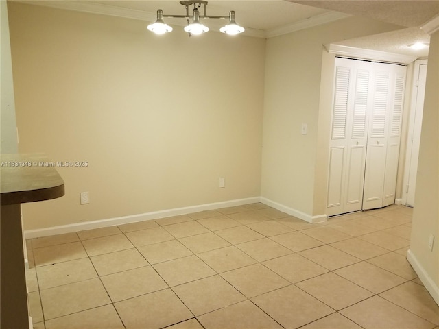 3995 W Mcnab Rd Unit B105, Pompano Beach, FL 33069 - unfurnished dining area featuring ornamental molding and light tile patterned floors