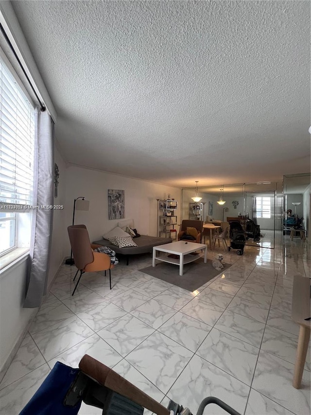 1913 S Ocean Dr Unit 302, Hallandale Beach, FL 33009 - living room featuring a textured ceiling and marble look tile flooring