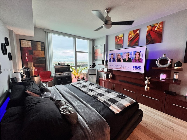 2641 N Flamingo Rd Unit 1203N, Sunrise, FL 33323 - bedroom featuring wood finished floors, ceiling fan, a textured ceiling, and floor to ceiling windows