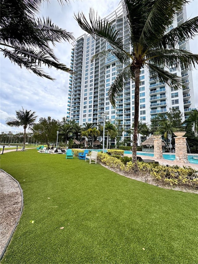 2641 N Flamingo Rd Unit 1203N, Sunrise, FL 33323 - surrounding community with a lawn and a pool