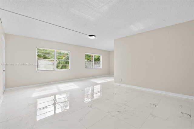 251 SW 132nd Way Unit 201H, Pembroke Pines, FL 33027 - unfurnished room with a textured ceiling and light marble finish flooring