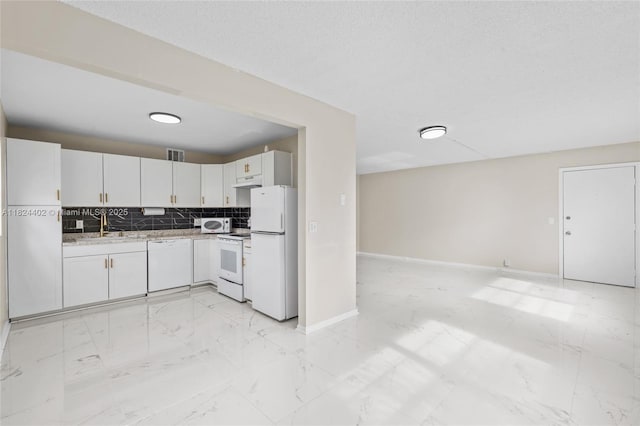 251 SW 132nd Way Unit 201H, Pembroke Pines, FL 33027 - kitchen featuring white appliances, light marble finish flooring, under cabinet range hood, backsplash, and white cabinetry
