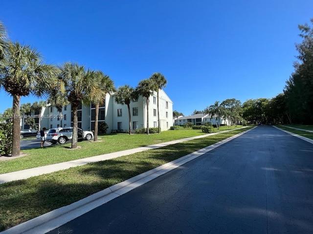 3606 Alder Dr Unit F2, West Palm Beach, FL 33417 - view of asphalt road with sidewalks and a residential view
