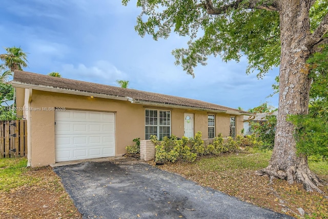 11035 NW 27th St, Sunrise, FL 33322 - ranch-style home with asphalt driveway, stucco siding, and an attached garage