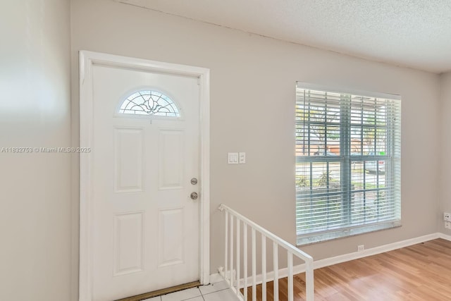 11035 NW 27th St, Sunrise, FL 33322 - foyer featuring healthy amount of natural light, light wood-style flooring, and a textured ceiling