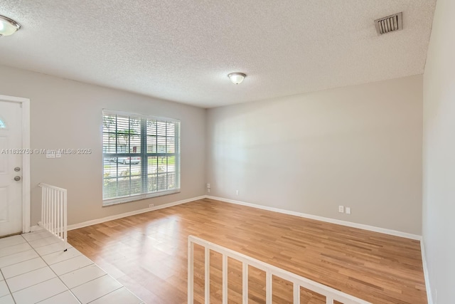 11035 NW 27th St, Sunrise, FL 33322 - spare room with light wood-style floors and a textured ceiling