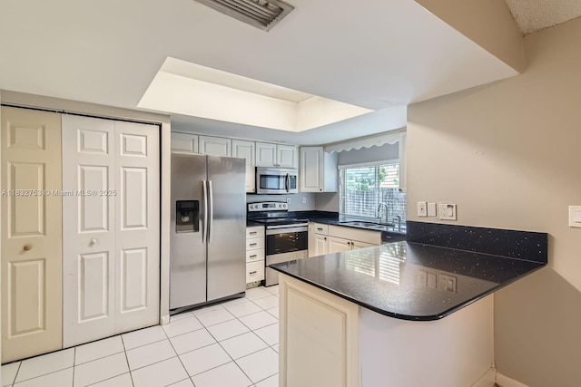 11035 NW 27th St, Sunrise, FL 33322 - kitchen with appliances with stainless steel finishes, a peninsula, and light tile patterned flooring