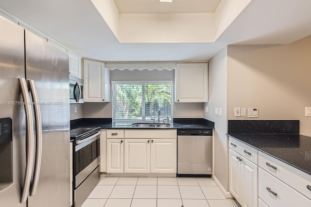11035 NW 27th St, Sunrise, FL 33322 - kitchen featuring stainless steel appliances, white cabinets, light tile patterned flooring, and dark stone counters