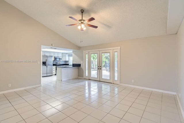 11035 NW 27th St, Sunrise, FL 33322 - empty room with ceiling fan, french doors, a textured ceiling, lofted ceiling, and light tile patterned flooring