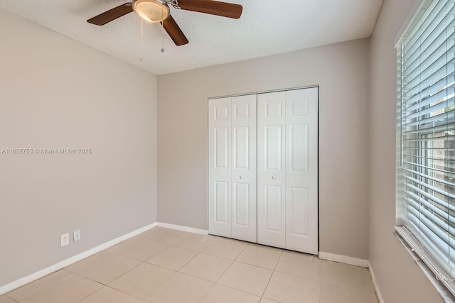 11035 NW 27th St, Sunrise, FL 33322 - unfurnished bedroom with light tile patterned flooring, a closet, a textured ceiling, and ceiling fan