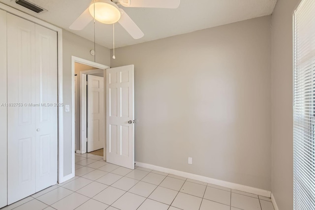 11035 NW 27th St, Sunrise, FL 33322 - unfurnished bedroom featuring a closet, ceiling fan, and light tile patterned floors