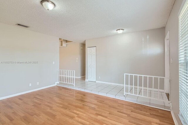 11035 NW 27th St, Sunrise, FL 33322 - empty room featuring light wood-type flooring and a textured ceiling